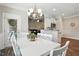Bright dining room with chandelier leads into the living room and kitchen at 116 Colonade Ct, Benson, NC 27504