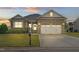 Charming brick home featuring a well-maintained lawn and an attached two-car garage at 116 Colonade Ct, Benson, NC 27504