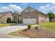 Attractive brick home, enhanced by a green lawn and a convenient two-car garage at 116 Colonade Ct, Benson, NC 27504