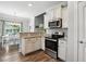 Modern kitchen with stainless steel appliances, white cabinets, and granite countertops at 116 Colonade Ct, Benson, NC 27504