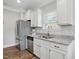 Well-lit kitchen featuring granite countertops, stainless steel appliances and white cabinets at 116 Colonade Ct, Benson, NC 27504