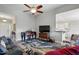 Stylish living room featuring a baby grand piano and partial view of kitchen at 116 Colonade Ct, Benson, NC 27504