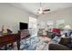 Open living room with cathedral ceilings, ceiling fan, hardwood floors and area rug at 116 Colonade Ct, Benson, NC 27504