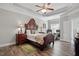 Spacious main bedroom featuring tray ceilings, ceiling fan, and seating area at 116 Colonade Ct, Benson, NC 27504