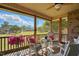 Porch with ceiling fan, wood floor, wooden railings and an outside view with green grass at 116 Colonade Ct, Benson, NC 27504