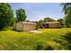 Large backyard with a metal shed, adjacent to a concrete pad, providing ample storage and functionality at 117 Castlerock Dr, Durham, NC 27713