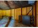Basement showcasing wooden support columns, plywood walls and a worktable, offering a space for storage or projects at 117 Castlerock Dr, Durham, NC 27713