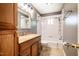 Bathroom featuring a shower and bath combo, neutral flooring, granite counters, and wood cabinetry at 117 Castlerock Dr, Durham, NC 27713