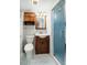 Small bathroom featuring a wooden vanity, toilet, a light fixture and shower at 117 Castlerock Dr, Durham, NC 27713