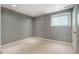 Serene bedroom featuring a window, tile flooring, and neutral wall paint at 117 Castlerock Dr, Durham, NC 27713