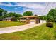 Traditional brick home with an attached garage and a long driveway, surrounded by mature trees at 117 Castlerock Dr, Durham, NC 27713