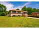Inviting home with brick facade, lush green lawn and mature trees in a quiet neighborhood at 117 Castlerock Dr, Durham, NC 27713