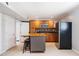 Well-lit kitchen with wooden cabinets, black appliances, and a functional island at 117 Castlerock Dr, Durham, NC 27713