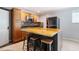 Kitchen area with dark stainless steel appliances, a center island with bar stool seating, and light-colored cabinets at 117 Castlerock Dr, Durham, NC 27713