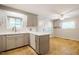 Stylish kitchen featuring gray cabinets, modern countertops, and an open layout to the breakfast nook at 117 Castlerock Dr, Durham, NC 27713