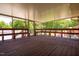 Inviting screened-in porch with wood decking and bench seating overlooking the lush backyard at 117 Castlerock Dr, Durham, NC 27713