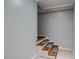 Staircase in a hallway with carpet treads, white walls, and white risers at 117 Castlerock Dr, Durham, NC 27713