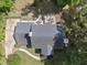 Aerial view of home with a backyard patio, firepit, outdoor seating, lush landscaping, and sidewalks at 117 Queensferry Rd, Cary, NC 27511