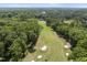 Aerial view of property backing to a golf course surrounded by mature trees at 117 Queensferry Rd, Cary, NC 27511