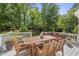 Charming outdoor dining area on back deck, surrounded by lush trees at 117 Queensferry Rd, Cary, NC 27511