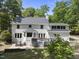 Expansive backyard featuring a spacious deck, stone patio, and lush landscaping at 117 Queensferry Rd, Cary, NC 27511