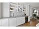 Elegant bar area with custom cabinetry, wine storage, and stylish backsplash, ideal for entertaining at 117 Queensferry Rd, Cary, NC 27511