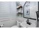 Charming powder room featuring shiplap walls, stylish mirror, and decorative shelving at 117 Queensferry Rd, Cary, NC 27511