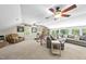 Spacious bonus room with large windows, a sectional sofa, and a ceiling fan at 117 Queensferry Rd, Cary, NC 27511