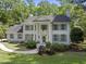 Stately white brick home with gray shutters, complemented by lush landscaping and a charming walkway at 117 Queensferry Rd, Cary, NC 27511