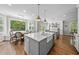 Bright, open kitchen with a large island, dining area, and abundant natural light at 117 Queensferry Rd, Cary, NC 27511