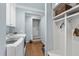 Well-organized laundry room with washer, dryer, storage cabinets, and mudroom area at 117 Queensferry Rd, Cary, NC 27511
