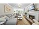 Cozy living room with fireplace, plush seating, and open layout to kitchen, perfect for gatherings at 117 Queensferry Rd, Cary, NC 27511