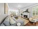 Cozy living room with fireplace, plush seating, and open layout to kitchen, perfect for gatherings at 117 Queensferry Rd, Cary, NC 27511