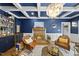 The living room has a brick fireplace, coffered ceilings, a full bar, and comfortable leather seating at 117 Queensferry Rd, Cary, NC 27511