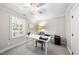 Well-lit home office with window shutters, ceiling fan, and simple decor at 117 Queensferry Rd, Cary, NC 27511