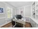 Bright office space featuring wainscoting, hardwood floors, plantation shutters, and custom built-ins at 117 Queensferry Rd, Cary, NC 27511