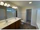 Bright bathroom features double vanity, large mirror, neutral color palette, and walk in closet at 1208 Olympic Dr, Mebane, NC 27302
