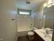 This bathroom features tiled floors, bathtub and shower with window, and single vanity at 1208 Olympic Dr, Mebane, NC 27302