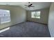 Spacious carpeted bedroom features vaulted ceiling, two windows, and neutral color palette at 1208 Olympic Dr, Mebane, NC 27302