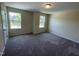 Cozy carpeted bedroom features two windows, neutral color palette, and standard closet at 1208 Olympic Dr, Mebane, NC 27302