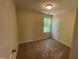 Carpeted bedroom features one window, neutral color palette, and standard closet at 1208 Olympic Dr, Mebane, NC 27302