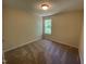 Small carpeted bedroom features one window and a neutral color palette at 1208 Olympic Dr, Mebane, NC 27302