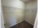 Walk-in closet features wire shelving, neutral color palette, and carpeted floor at 1208 Olympic Dr, Mebane, NC 27302