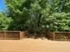 Decking area features wood railing and dense surrounding foliage at 1208 Olympic Dr, Mebane, NC 27302