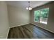 Bright dining area boasts hardwood floors and a large window with views of the outdoor space at 1208 Olympic Dr, Mebane, NC 27302