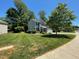 Charming two-story home with green lawn and beautiful landscaping at 1208 Olympic Dr, Mebane, NC 27302