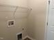 Practical laundry room with essential connections and minimalist shelving at 1208 Olympic Dr, Mebane, NC 27302