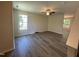 Comfortable living room with luxury vinyl plank flooring, ceiling fan, and natural light at 1208 Olympic Dr, Mebane, NC 27302