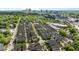 An aerial view of a neighborhood featuring many homes, trees, and the city in the distance at 1209 Harp St, Raleigh, NC 27604