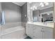 This bathroom features a tub and double sink with a large mirror at 1209 Harp St, Raleigh, NC 27604